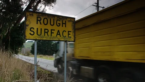 Heavy goods truck thunders past on country road. Stock Footage 92289358
