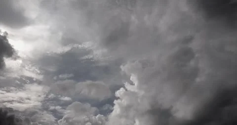 Heavy gray storm clouds fill the sky, signaling an approaching heavy rainstorm. 스톡 동영상 338750955