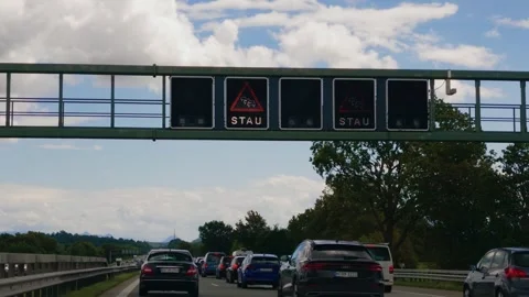 Heavy highway traffic jam and electronic warning signs on German Autobahn A8 in 스톡 동영상 346254415