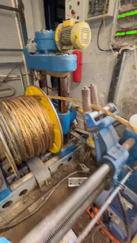 Heavy industrial machine with large spool of braided wire. Copper electrical Stock Footage 322002762