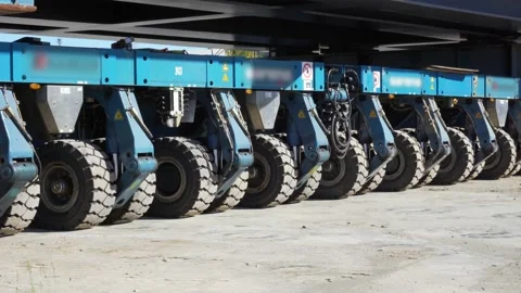 Heavy industrial self propelled modular trailer moving a train railway.  Stock Footage 133545022