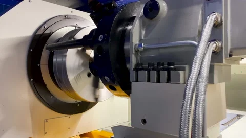 Heavy industrial worker performs a mechanical operation on a machine for the  库存影片 204153370