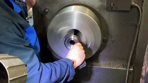 Heavy industrial worker performs a mechanical operation on a machine for the  Stock Footage 204153398