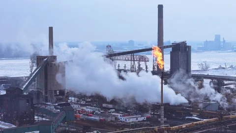 Heavy industry facility operating, generating emissions and flame on Zug Stock Footage 333895320