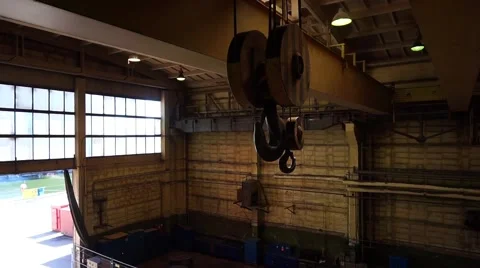 Heavy industry. Shipyard hall. Overhead crane hook is going down Stock Footage 64803697