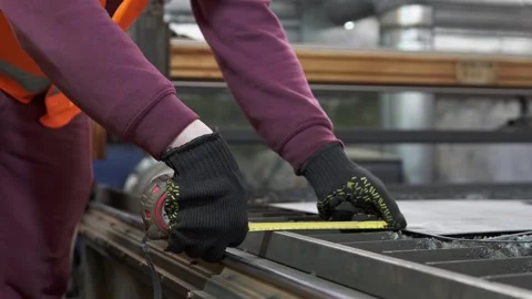 A heavy industry worker levels a sheet of metal for plasma cutting. Stock Footage 276549483