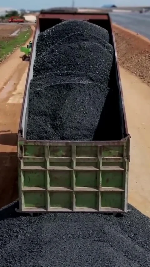 A Heavy Load Composed of Black Material Is Currently Being Unloaded During Stock Footage 312528660