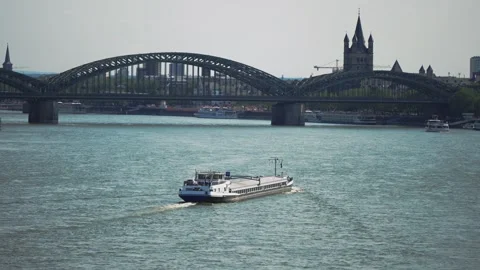 Heavy long cargo barge sailing on the Rhine river in Cologne, Germany, aerial Video stock 321306835