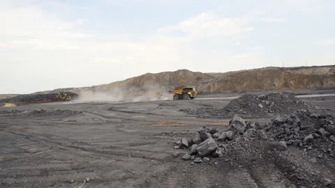 Heavy Machinery is Actively Operating in a Large Open Pit Mining Site Stock Footage 281561872