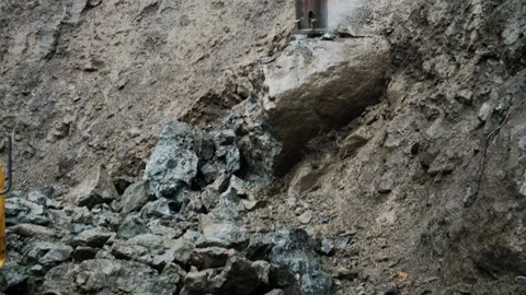 Heavy Machinery is Breaking Ground at a Construction Site, drilling rock Video stock 302217971