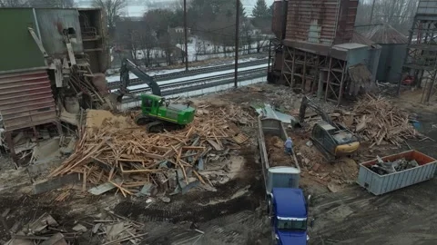 Heavy Machinery Clears Debris and Broken Wood From a Construction Site in t.. Stock Footage 334257109