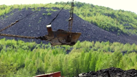 Heavy Machinery Efficiently Operating in a Lush, Green Mining Landscape Stock Footage 282736032