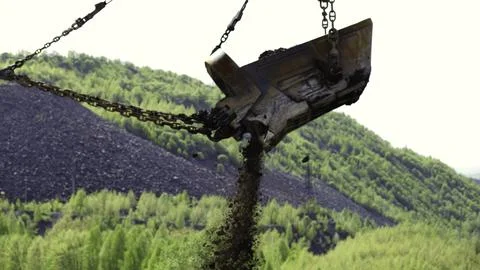 Heavy Machinery Efficiently Operating in a Lush, Green Mining Landscape Stock Photos