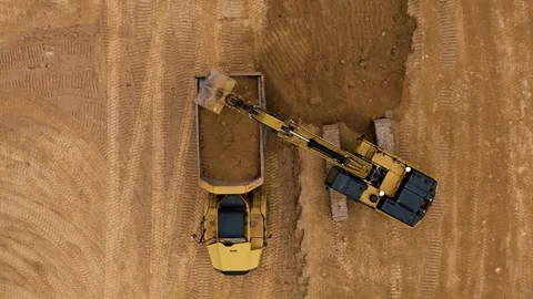 Heavy Machinery is Loading Dirt on a Construction Site for Ongoing Projects and Stock Footage 312172473