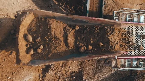 Heavy machinery loading stones conveyor belt crushing screening plant. Aerial Video stock 243736103