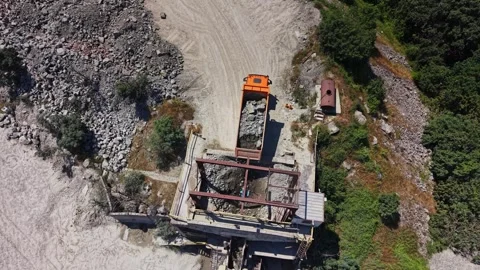 Heavy machinery loads materials at construction site near riverbank Stock Footage 339056965