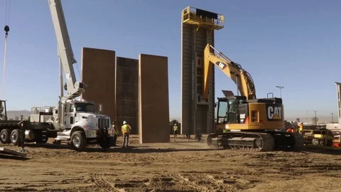 Heavy machinery moving large sheet of steel for large wall Stock Footage 114085212