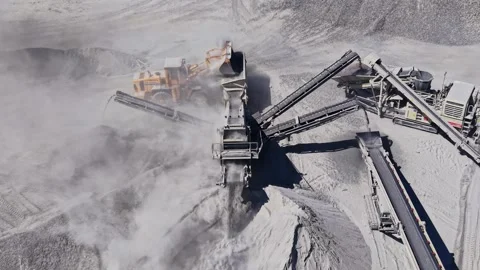Heavy machinery operates in a quarry during daylight hours Stock Footage 344538847