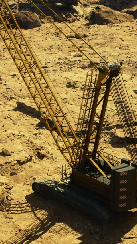 Heavy machinery operates on rugged terrain during daylight hours Stock Footage 329679286