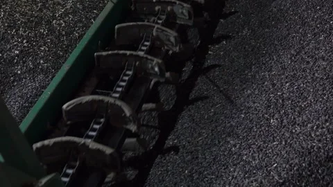 Heavy machinery is operating on a solid asphalt surface during the ongoing Stock Footage 310315824