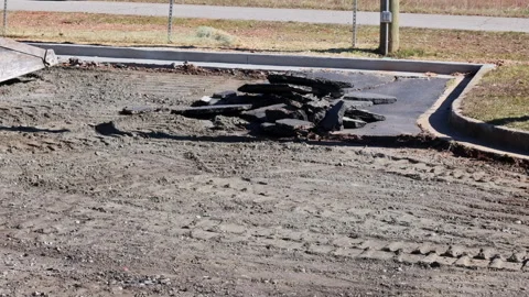 Heavy machinery removing asphalt in construction site for surface repair work Stock Footage 337497557