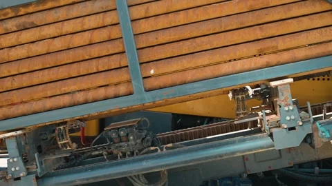Heavy machinery is unloading cargo using specialized equipment on a construction Stock Footage 338446743