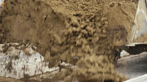 Heavy Machinery at Work An Excavator Efficiently Dumping Dirt on a Busy Stock Footage 312698370