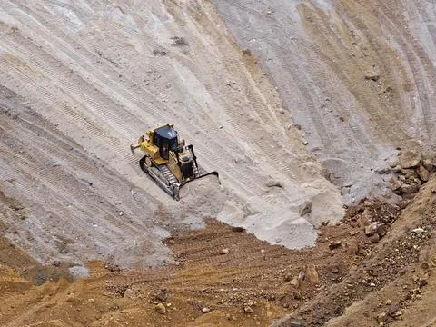 Heavy machinery working at the bottom of an open pit mine Stock Photos
