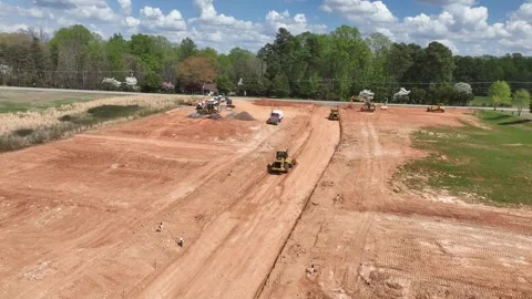 Heavy machinery working on empty dirt lot aerial perspective Stock-Footage 335017395