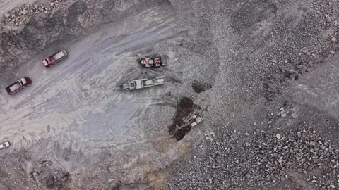 Heavy machinery working in a stone quarry during daylight hours Stock Footage 338275943
