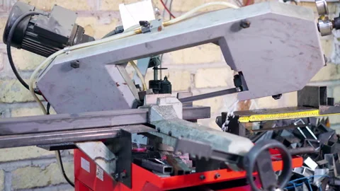 Heavy machinery in workshop, process of cutting metal bar with sharp saw and Video stock 265407533