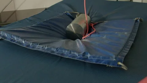 A heavy mass falls from above in slow motion and crushes a mattress, laboratory  Stock Footage 289546176