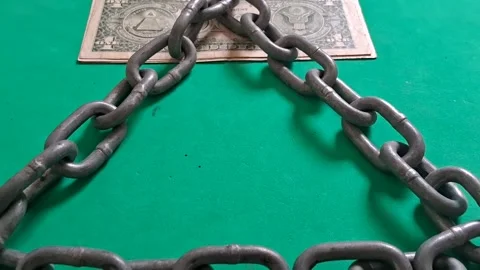 Heavy metal chains forming triangle around dollar bill motion clip Stock Footage 339302058