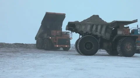 Heavy mining dump trucks driving along the opencast Stock Footage 10773434