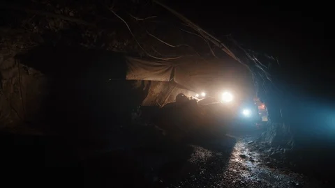 Heavy mining machinery moves inside dark narrow tunnel in copper pyrite mine Stock Footage 120227672