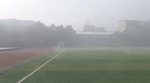 Heavy mist flowing on the empty soccer playground in a high school Stock Footage 44981995