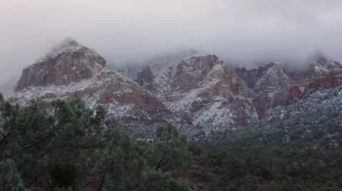 Heavy, Misty Clouds over Snowy Mountains in Sedona Stock Footage 8955424