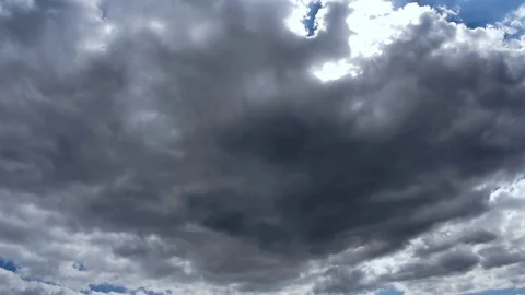 Heavy moving dark rain clouds covering a blue sky, timelapse Stock Footage 78210592