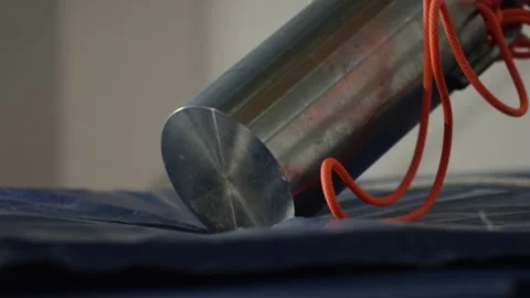 Heavy object falls from above in slow motion and crushes a mattress, laboratory Stock Footage 289546245