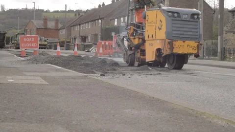 Heavy plant tarmac machinery and road cones on closed road wide low shot Stock Footage 127997710