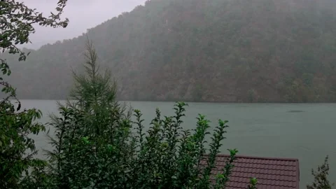 Heavy pouring rain over mountain lake Stock Footage 141848274