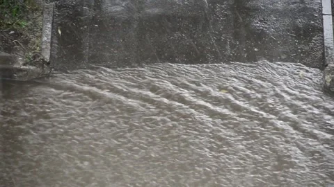 Heavy rain against the tree and a children's playground streams of water Vidéo 143336087