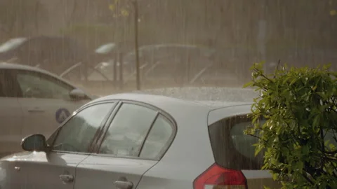 Heavy rain and hail falling on parked cars Stock Footage 305826211