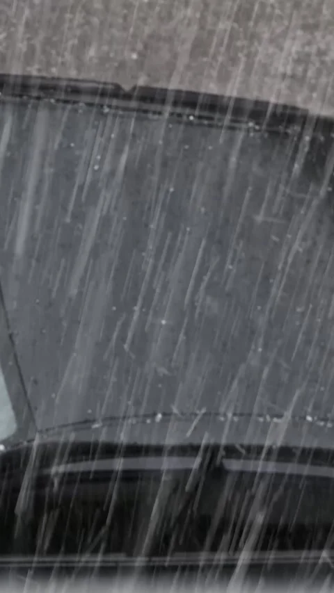 Heavy rain and hail falling on the roof of a black car. View from above. Stock Footage 306149587