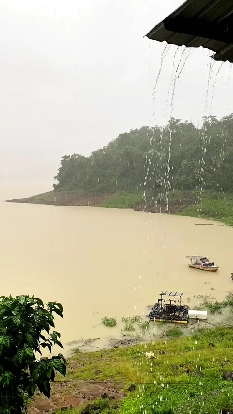 Heavy Rain and Raindrops View while looking at fishing boats on the Lake. 4K Video stock 301449814