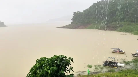 Heavy Rain and Raindrops View while looking at fishing boats on the Lake. 4K Video stock 301449825