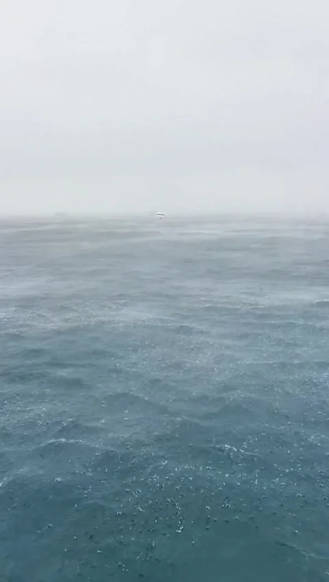 Heavy Rain and Rough Ocean Waves During Storm With Boat Distance Stock Footage 341522673