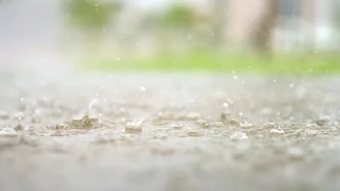 Heavy rain and splashes puddles taken from low point. Stock Footage 262178206