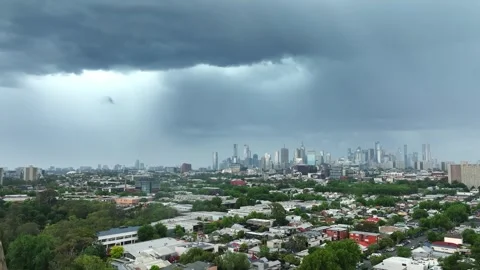 Heavy rain and storm clouds advancing over a city skyline Stock Footage 327945878