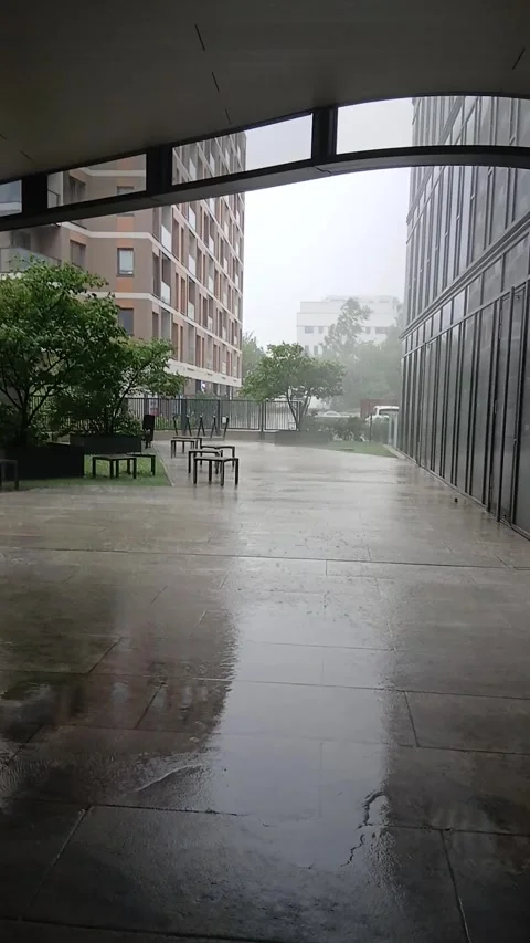 Heavy rain and thunderstorm in a modern residential courtyard Stock Footage 341269395